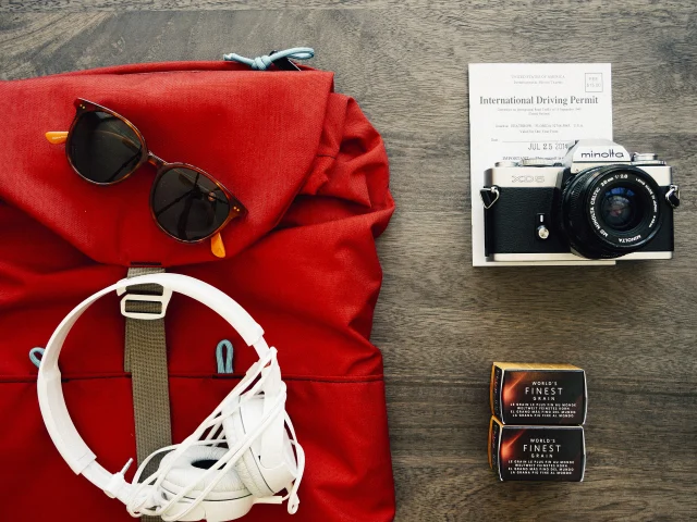 Travel backpack flat lay with accessories