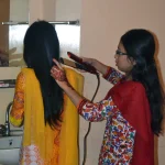 Hair straightening tool in use
