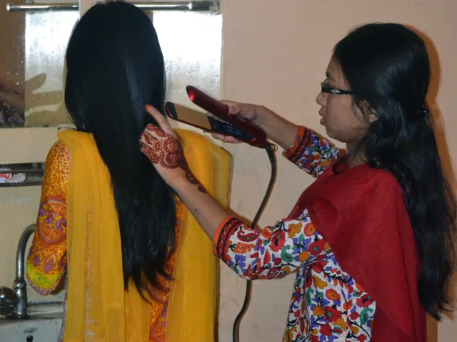 Hair straightening tool in use