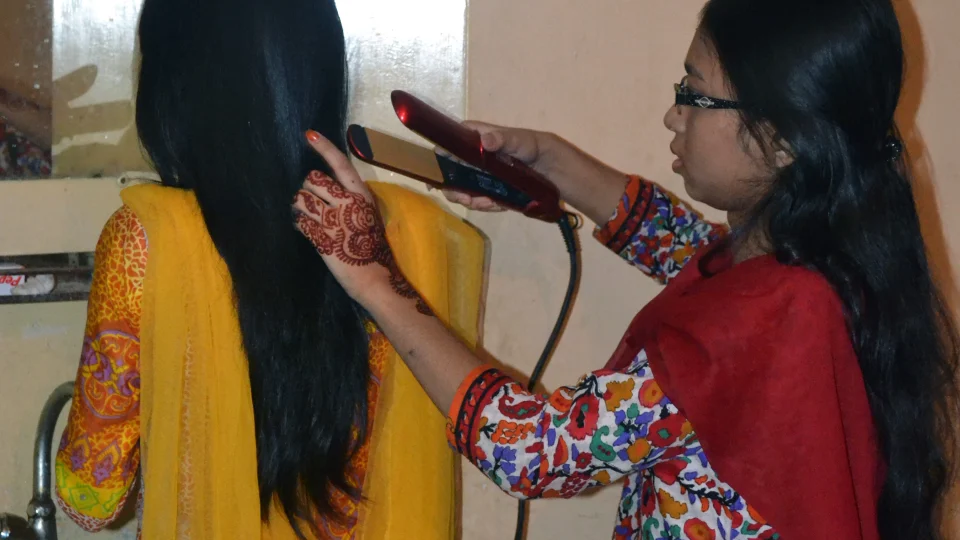 Hair straightening tool in use