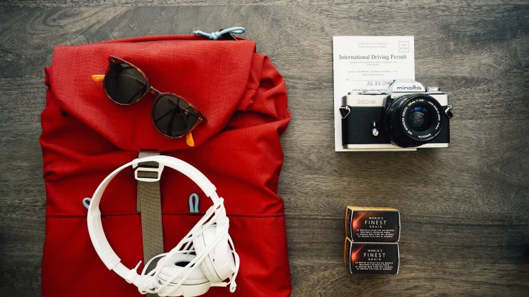 Travel backpack flat lay with accessories