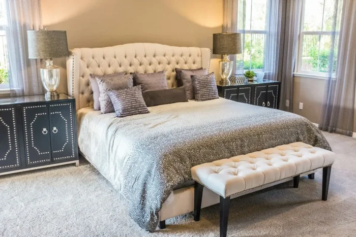 Bedroom with a made bed and pillows, representing mattress deals