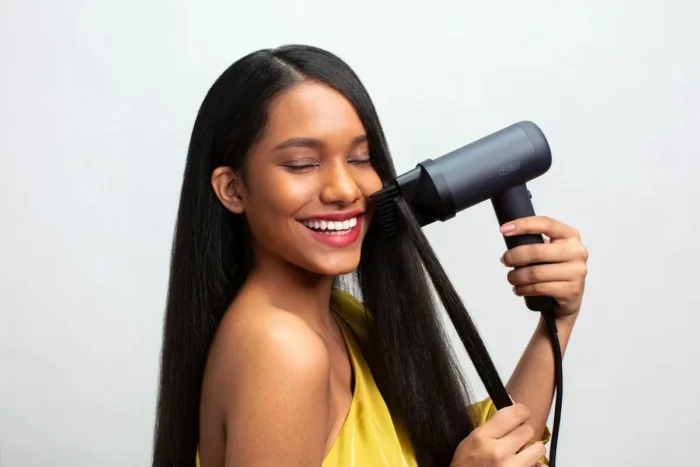 Woman drying her hair with a hair dryer